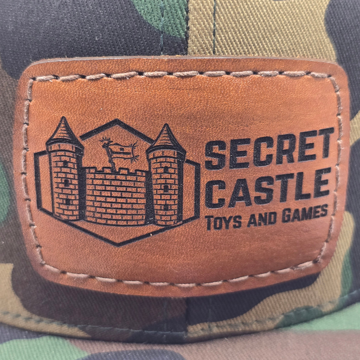 Woodland Camo Secret Castle Logo Mesh Trucker Cap